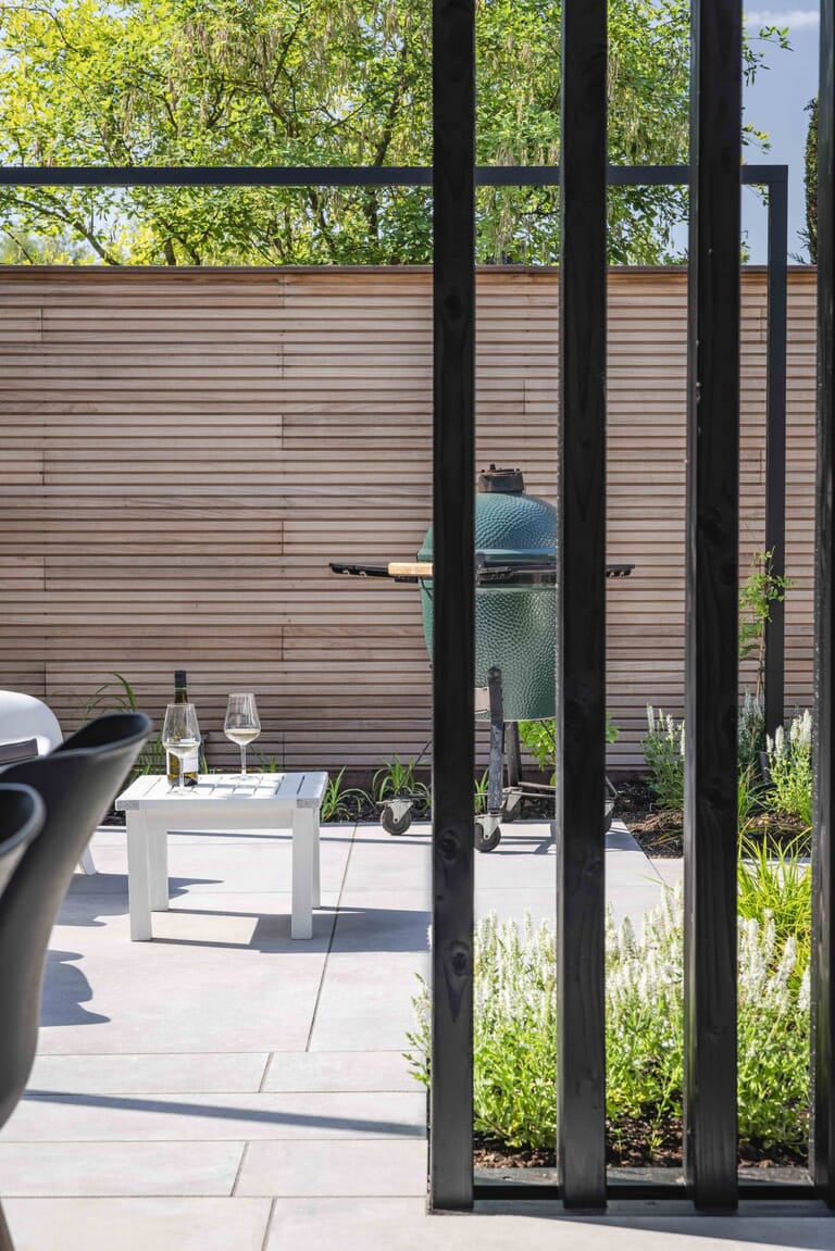 Tuin met mediterrane bomen, aluminium pergola en overkapping