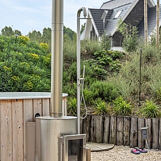 Ruimtelijke wellness tuin met hottub en buitendouche