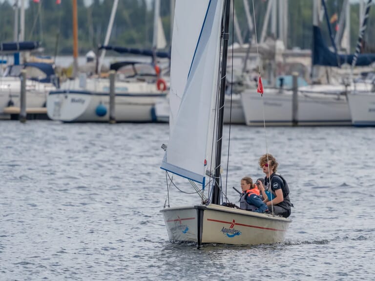 Twee mensen in een kleine zeilboot