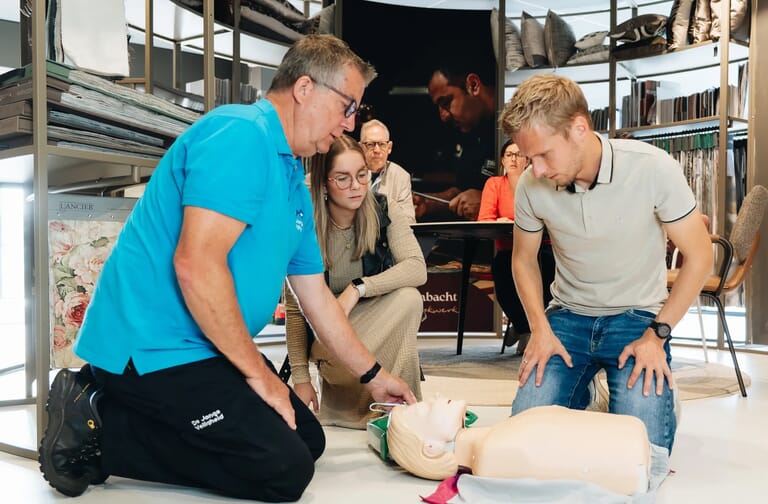 Mensen rondom een reanimatie pop