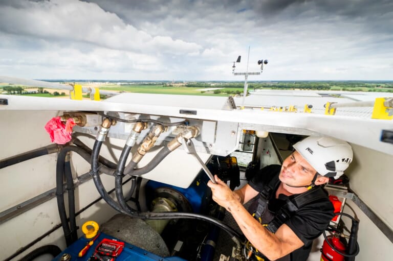 Een schip waar een man sleutelt aan aansluitingen